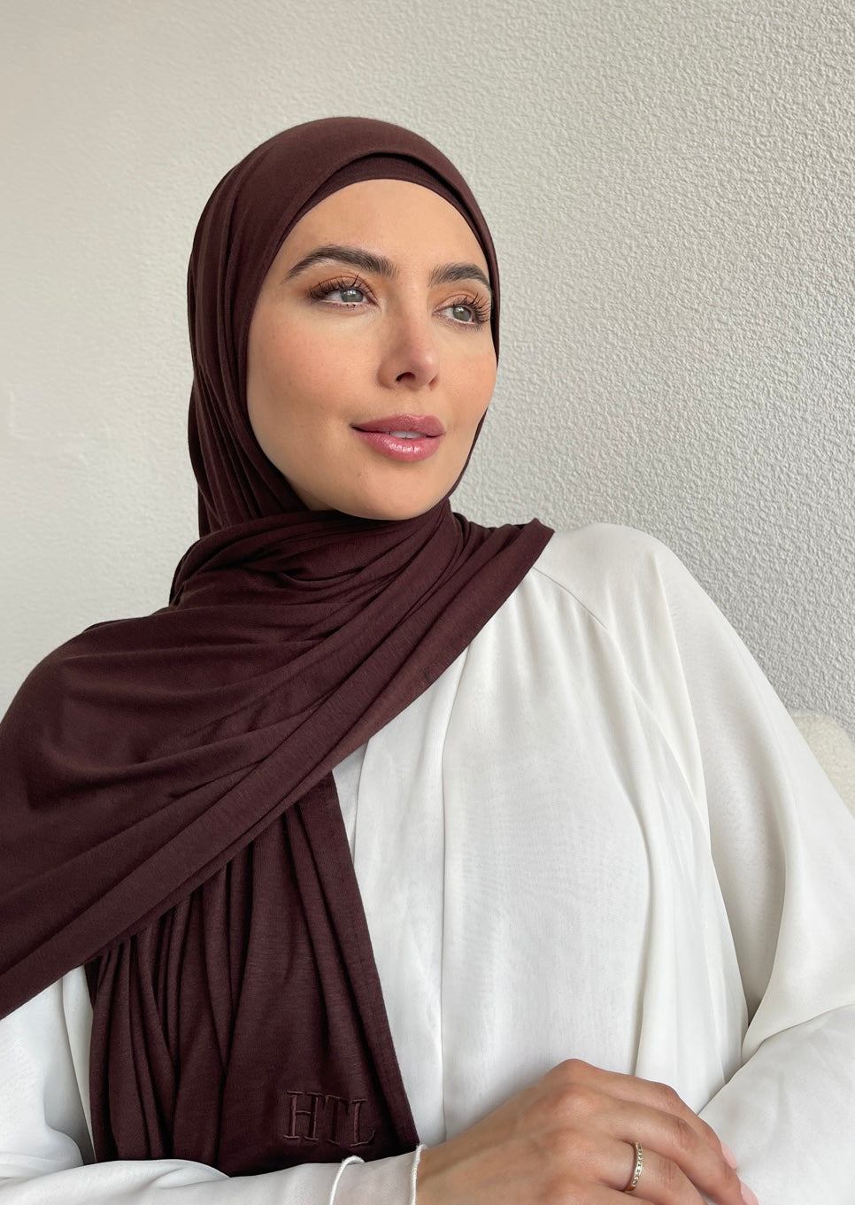 A muslim woman wearing a brown chocolate jersey hijab from hayaa the label ltd.