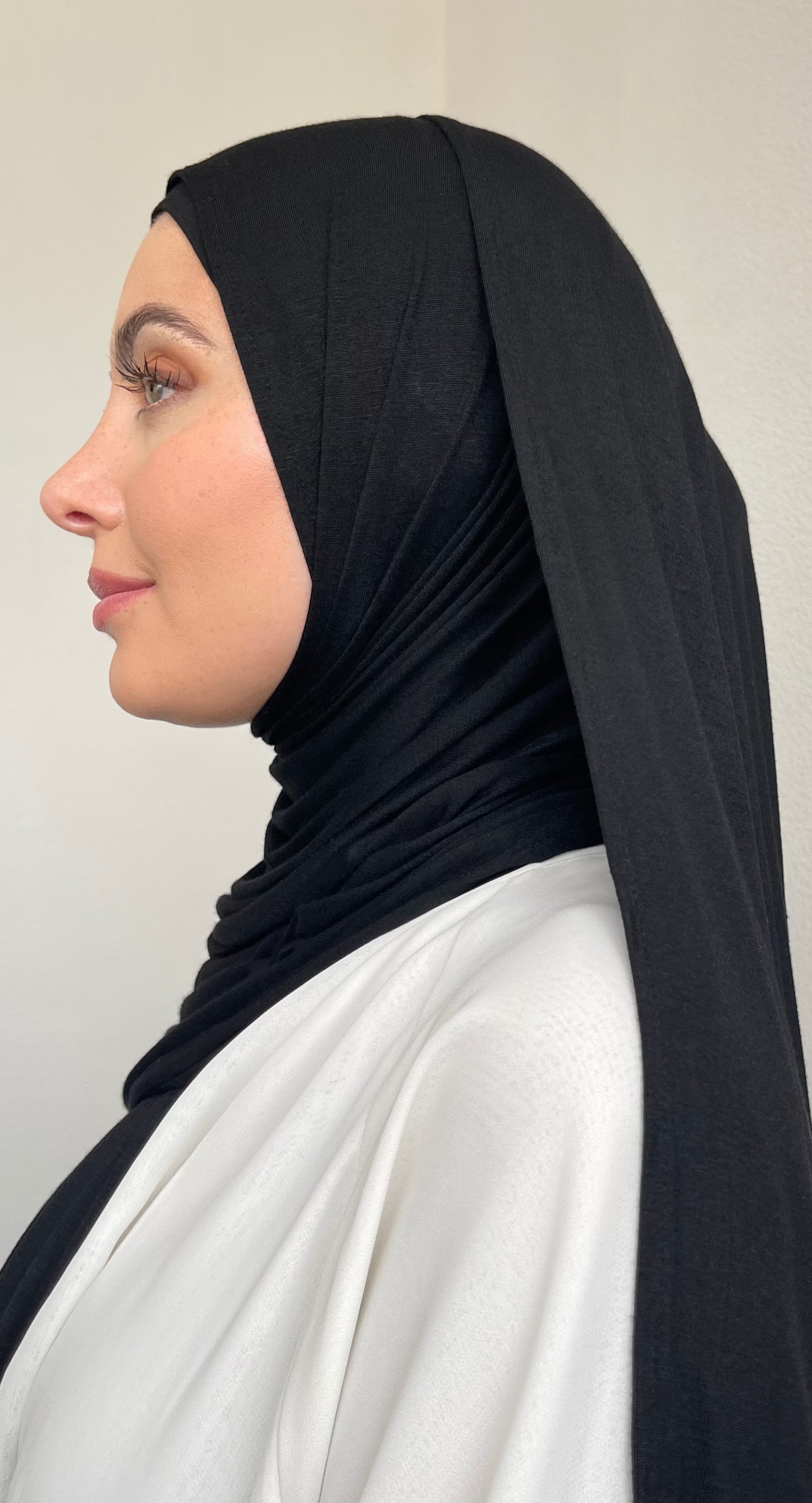 A muslim women fully covered in premium black jersey hijab.