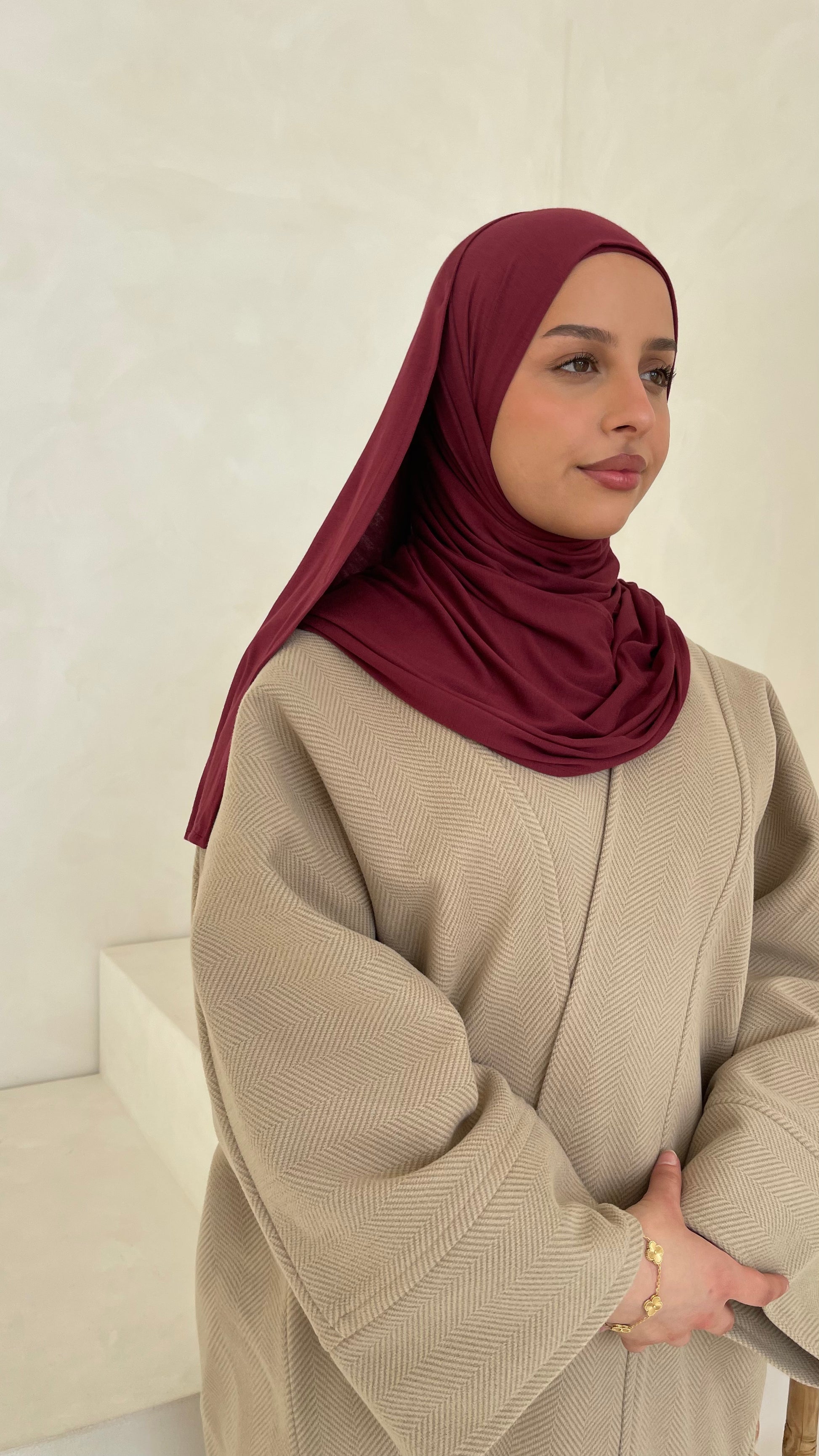 Muslim women wearing most popular hijab style in the colour burgundy. 