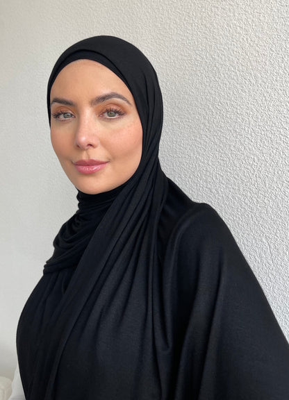 A woman wearing a jet black jersey hijab.