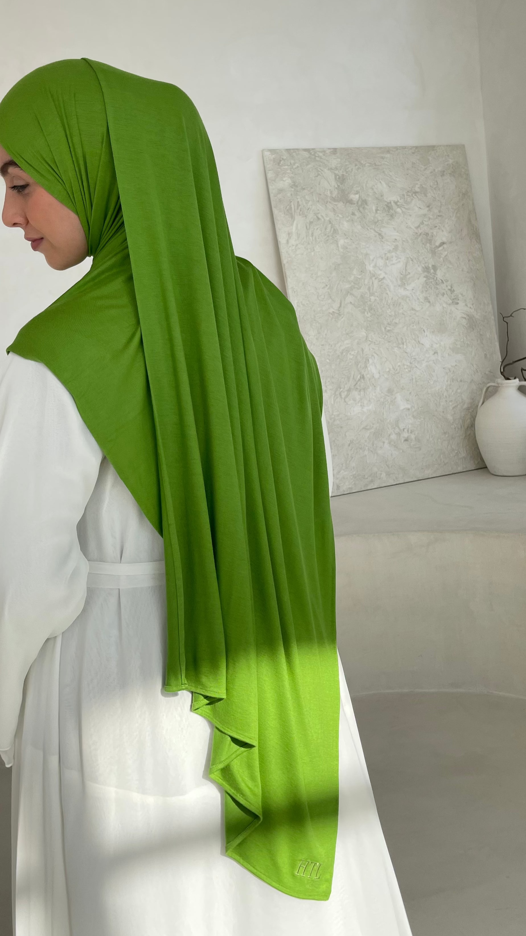Luxury modest clothing brand. Muslim women wearing Maxi jersey green hijab from hayaa the label ltd.
