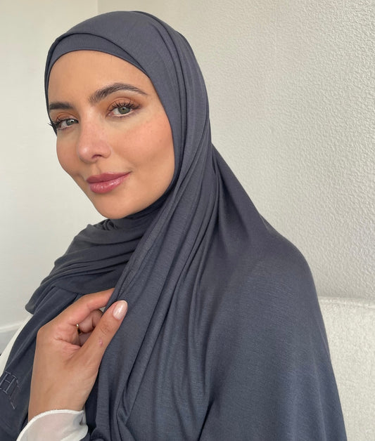 A muslim woman wearing a grey premium lightweight jersey hijab. 