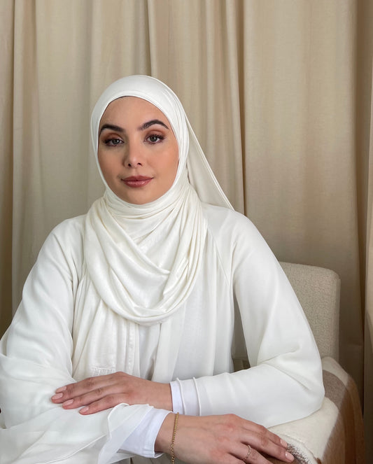 A woman wearing a white premium lightweight jersey hijab from hayaa the label ltd.